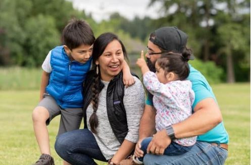 Family photo of a man, woman, and two young children all of native American descent