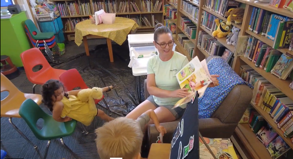 Sharee Miller, librarian, reading books to children at storytime