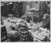Librarians helping patrons at a circulation desk. Missoula Public Library 1950s