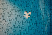 Blue puzzle with piece missing, leaving a white space