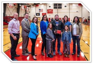 Teacher of the year Bill Stockton pictured with his family and State Superintendent of Public Instruction