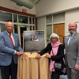 Transit Director Brian Litchfield with Howard and Lillian Lee in front of their plaque