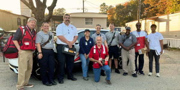 Group of Town staff and fire personnel with American Red Cross representatives at local manufactured home community