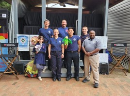 Fire personnel with puppets in front of stage at State Fair