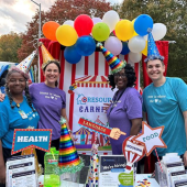 Affordable Housing and Community Connections staff in front of Resource Carnival at trunk-or-treat