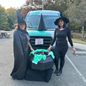 Library staff dressed as witches with cauldron