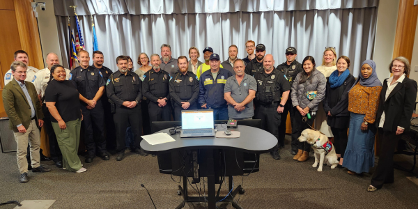Group of employees deployed to Western North Carolina in front of dais with Council members