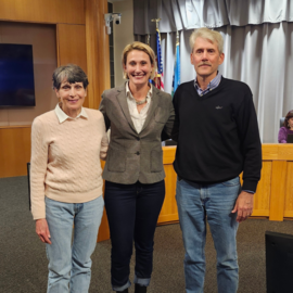 Community members with Mayor Anderson in front of dais