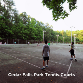 People playing tennis at Cedar Falls Park tennis courts