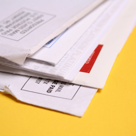 Pile of bills on yellow background