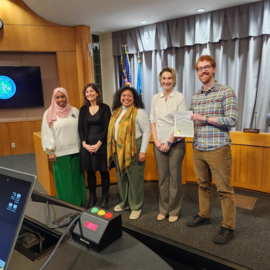 Council members presenting Mentoring Month proclamation at Council Chamber dais
