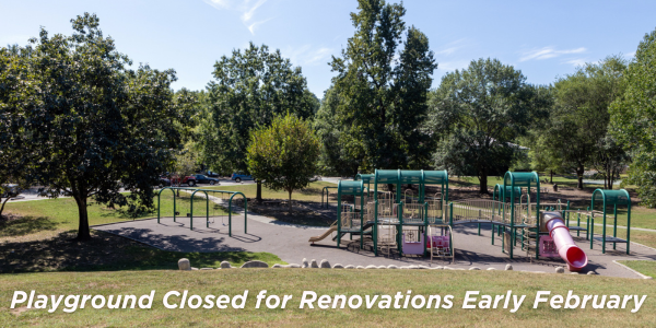 Community Center Park playground with playground equipment surrounded by trees