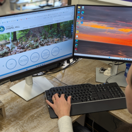 Computer screen with person at keyboard