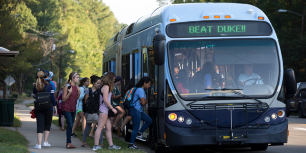 Chapel Hill Transit bus with Beat Duke running across the top and people lined up to board