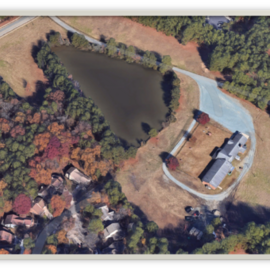 Aerial view of property at 1714 legion road including building and pond