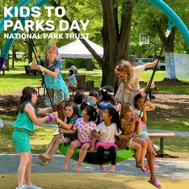 Kids playing on a tire swing at Community Center park