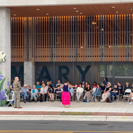 People in front of Rosemary Parking Deck performing