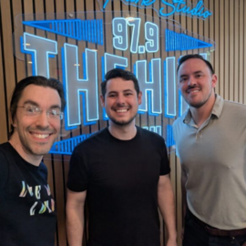 Town employees with Aaron Keck in front of 97.9 The Hill illuminated sign