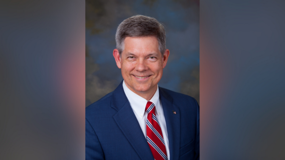 Ted Voorhees in blue suit with striped red tie