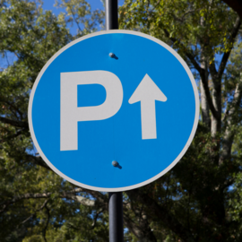 Blue circle with white trim that says the letter P with an arrow pointing up