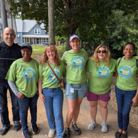 Town staff members smiling in green Good Neighbor Initiative shirts