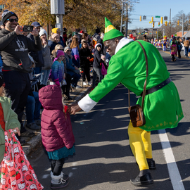 Person in E.L.F. costume handing out candy