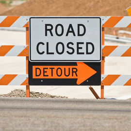 Road closed sign with detour sign