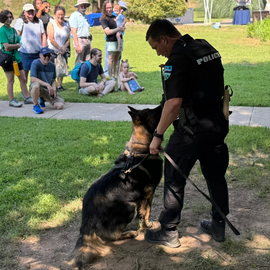 Officer with K9 giving a demonstration to people
