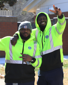 Public Works employees smiling in reflective jackets