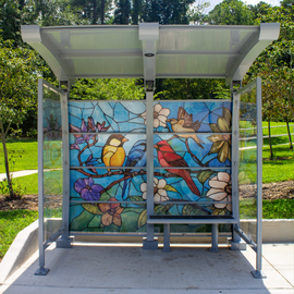 Artwork by Leticia Mendes of birds on a bus shelter