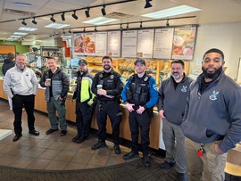 Police officers standing in front of a coffee bar as part of Coffee with a Cop