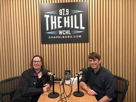 Alyson West and Brennan Bouma sitting in WCHL's radio studio to talk about Bike Month in Chapel Hill