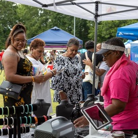 Community members interacting with vendors at Juneteenth celebration
