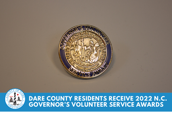 Image of a service pin. Text overlay reads, "Dare County Residents Receive 2022 N.C. Governor’s Volunteer Service Awards"