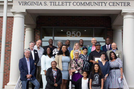 Image of the family of Virginia S. Tillett standing on the steps of the community center.
