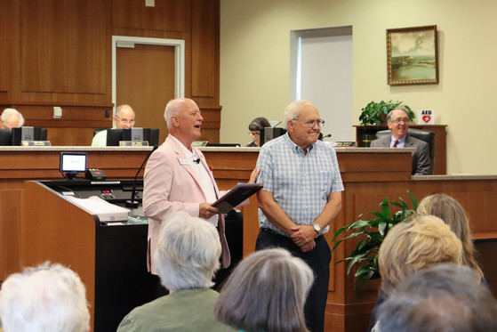 Dare County Board of Commissioners Chairman Bob Woodard presents the 2022 Dare County Citizen of the year award to Dennis Carroll.