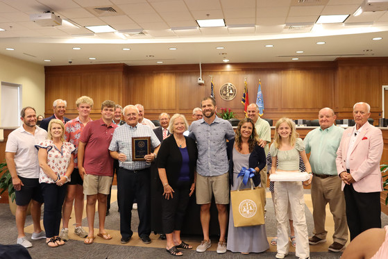 Dennis Carroll stands with the Dare County Commissioners and members of his family who were in attendance during his award presentation.