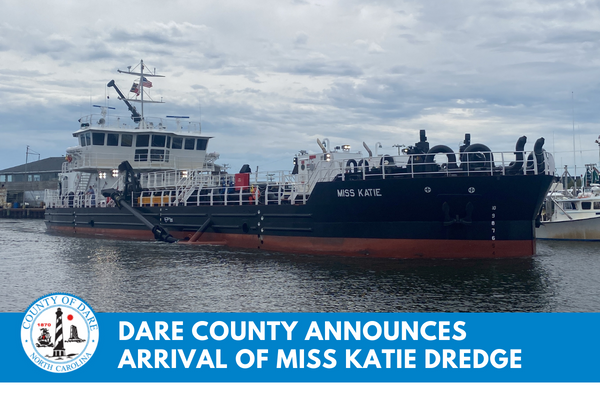 Image of the Miss Katie entering the Wanchese Harbor. Text overlay reads, "Dare County Announces Arrival of Miss Katie Dredge"