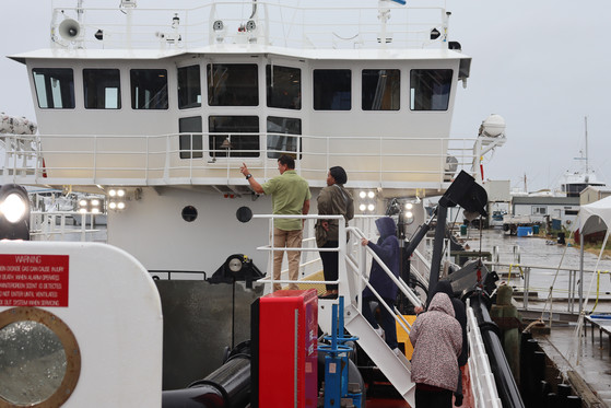 Image of a man giving a group tour of the Miss Katie.