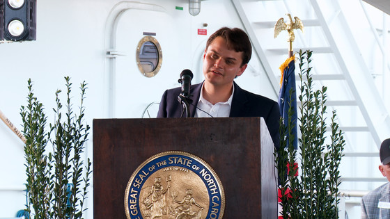 Image of EJE Dredging Service Vice President Jordan Hennessy speaking during the christening event in Wanchese Marine Industrial Park.