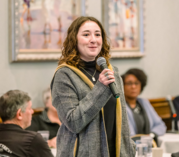 Image of Trasa Rossi speaking into a microphone.