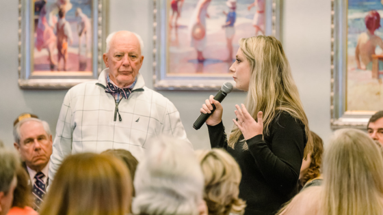 Image of Chairman Woodard and Kait Daniels speaking to the crowd.