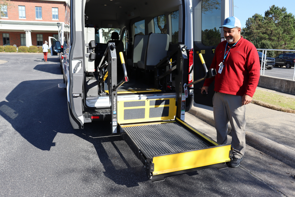 Image of Radcliff Hester testing the wheelchair lift in one of the new transportation vans.
