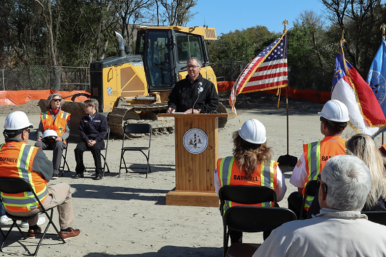 Image of Bobby Outten speaking at a podium.