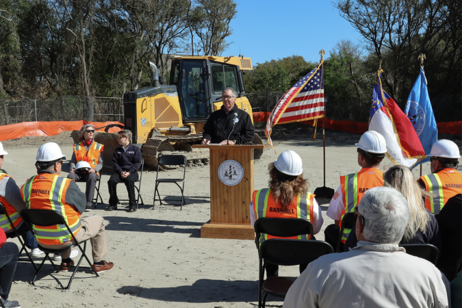 Image of Bobby Outten speaking at a podium.