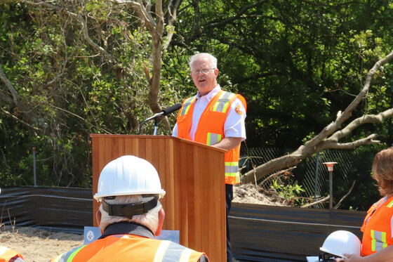 Image of Chief Troy Tilley standing at a podium speaking to the crowd.