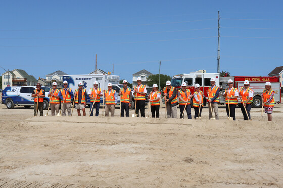 Image of a line of county and town officials holding shovels, ready to break ground.