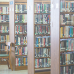 Image of library shelves filled with books.