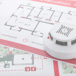 Image of an evacuation plan and fire alarm.