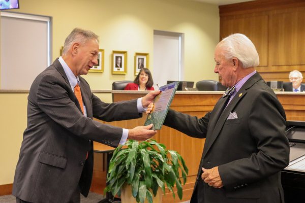 Image of Chairman Woodard handing an award to David Clawson.